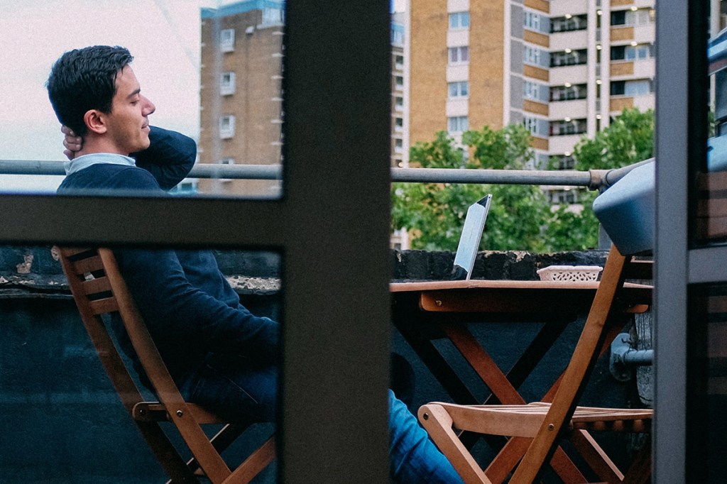 property manager working from laptop on patio