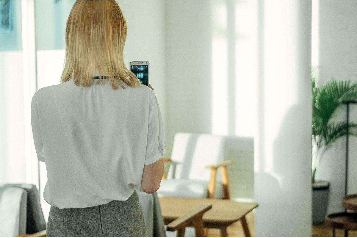 property manager taking photos of apartment with smartphone