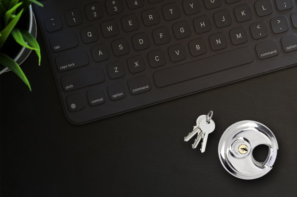 Self storage lock and keys on desk with a keyboard
