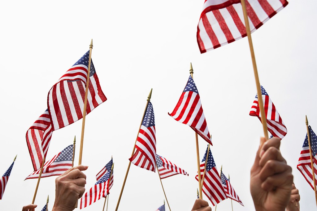 Property managers celebrating federal holidays with residents while waving American flags