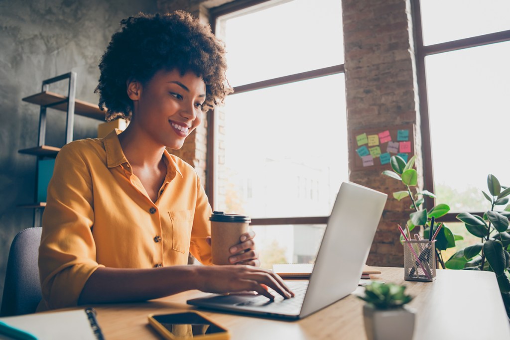 Property manager working remote and social distancing on her laptop