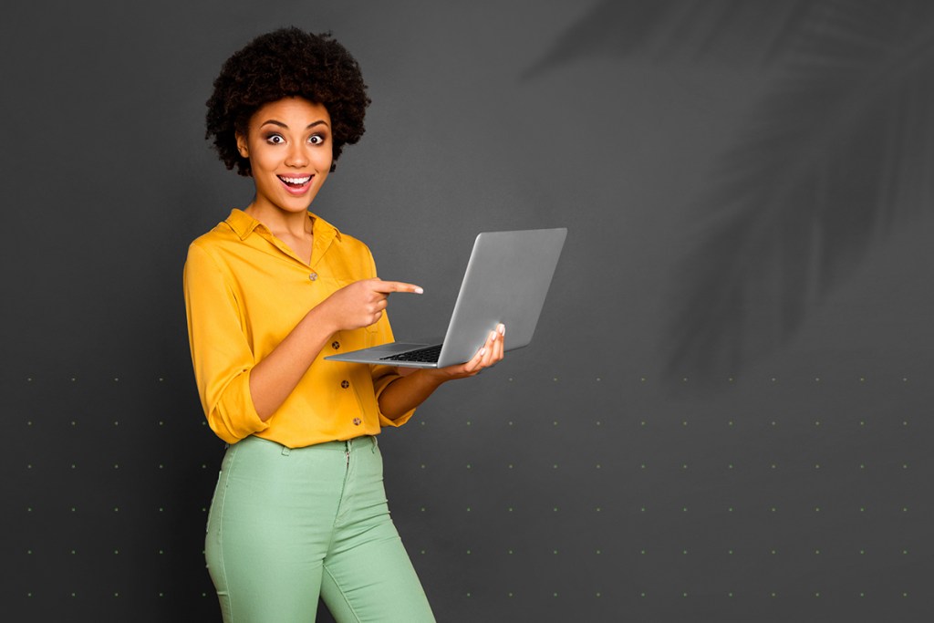 Excited woman supercharging her property management business with a laptop and property management software