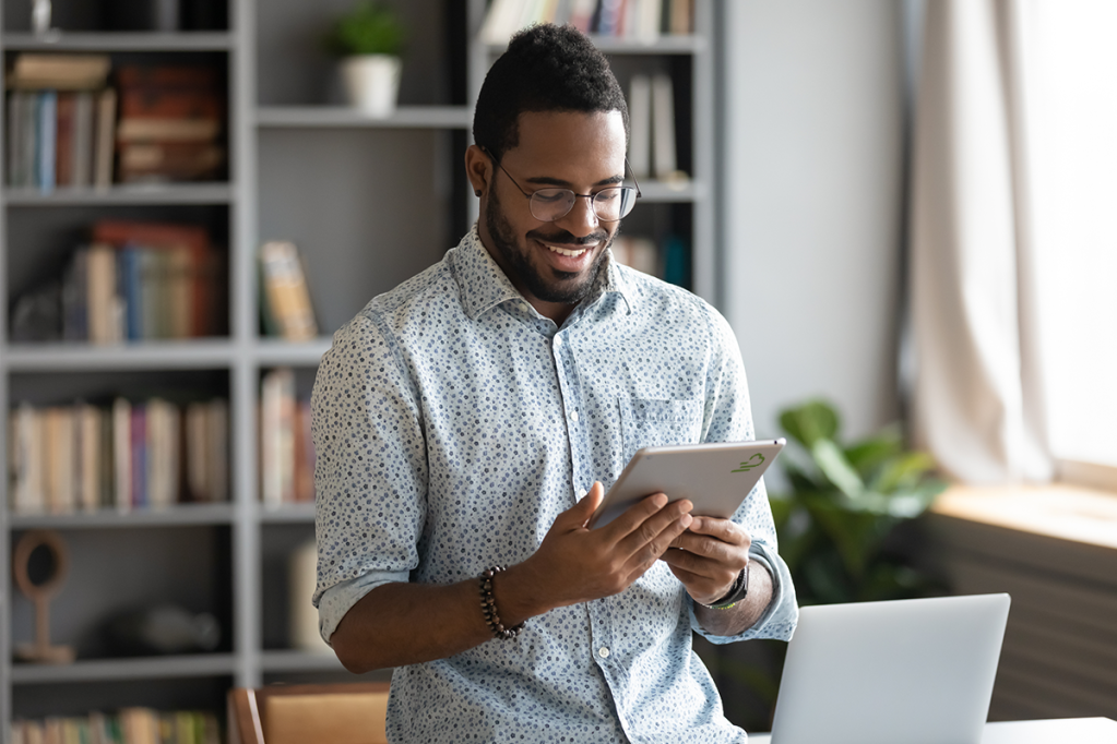 Man using a tablet, having upgraded from spreadsheets to property management software