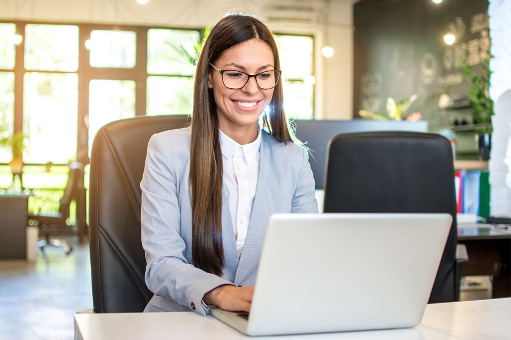 Property manager helping residents with deferred payments on her laptop