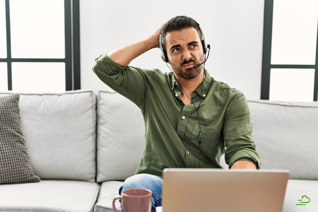 Man scratching his head as he contemplates whether he needs a real estate license for property management