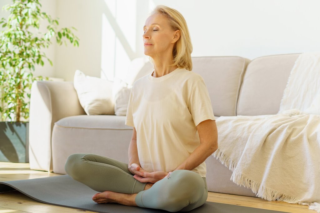 Woman meditating as a way to focus on mental health