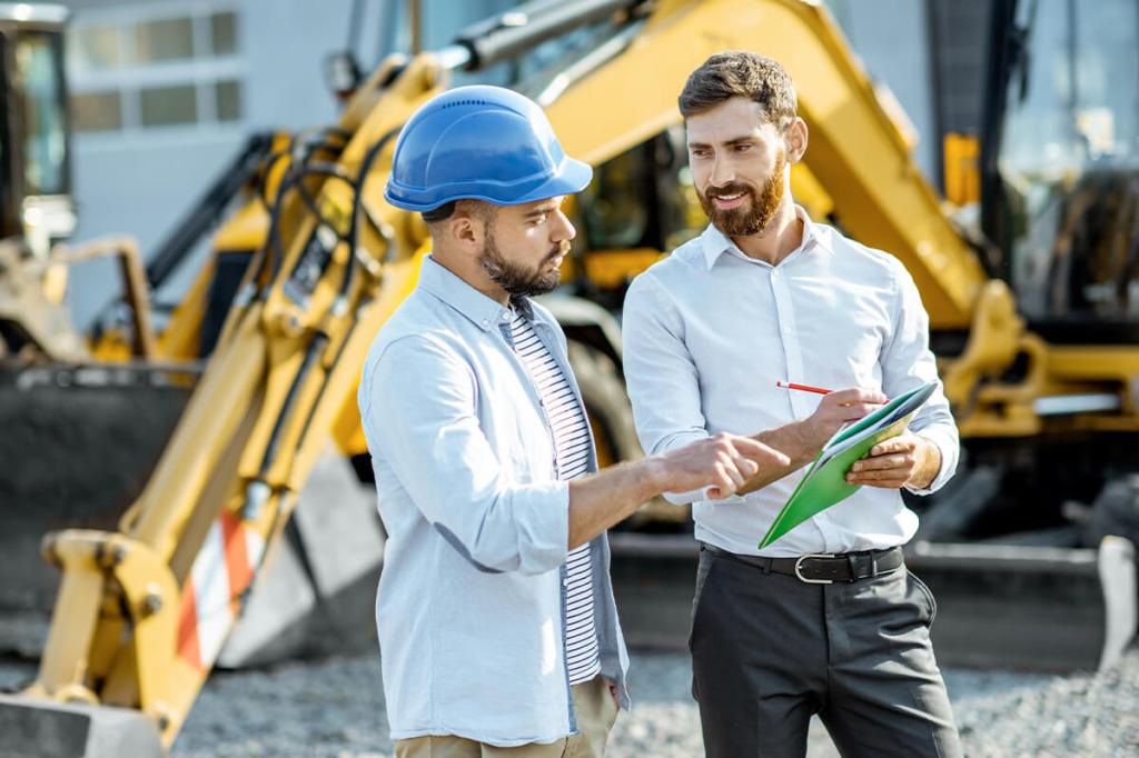 Property manager in hard hat with vendor to assess risk during project management