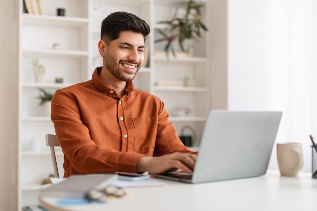 Man reading the best property management blog articles on a laptop.