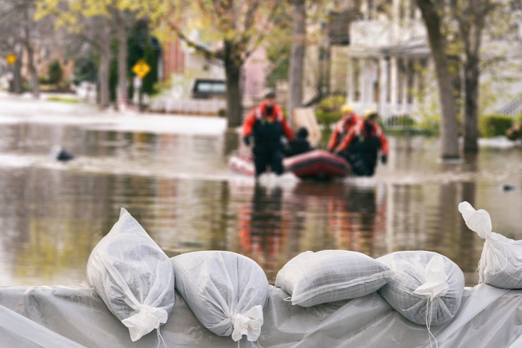 Image of flood wall by a small lake: Property Insurance Rates Rise Where Climate Change Hits Hardest