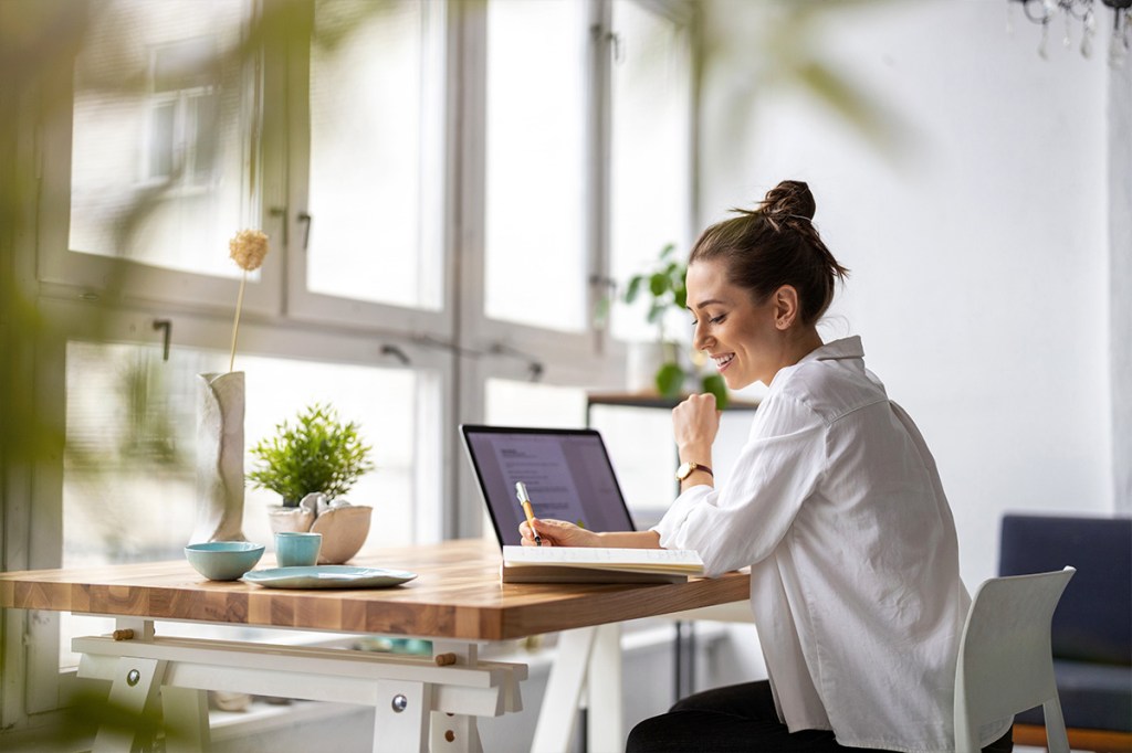 Woman at computer evaluating QuickBooks, Accounting Software, vs. Property Management Software