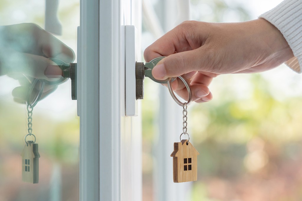 Hand turning key in door