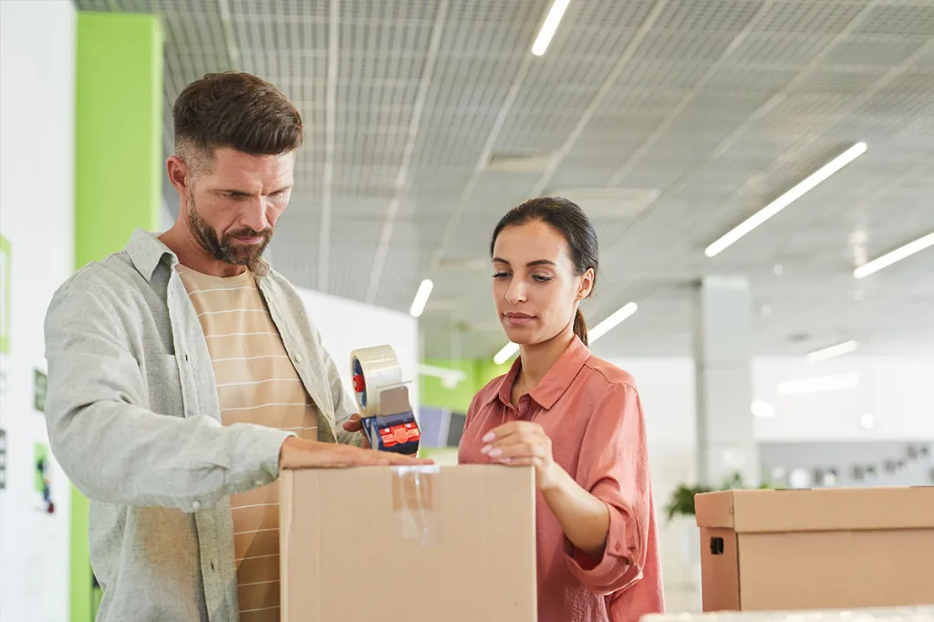 Man and woman putting a box into self storage