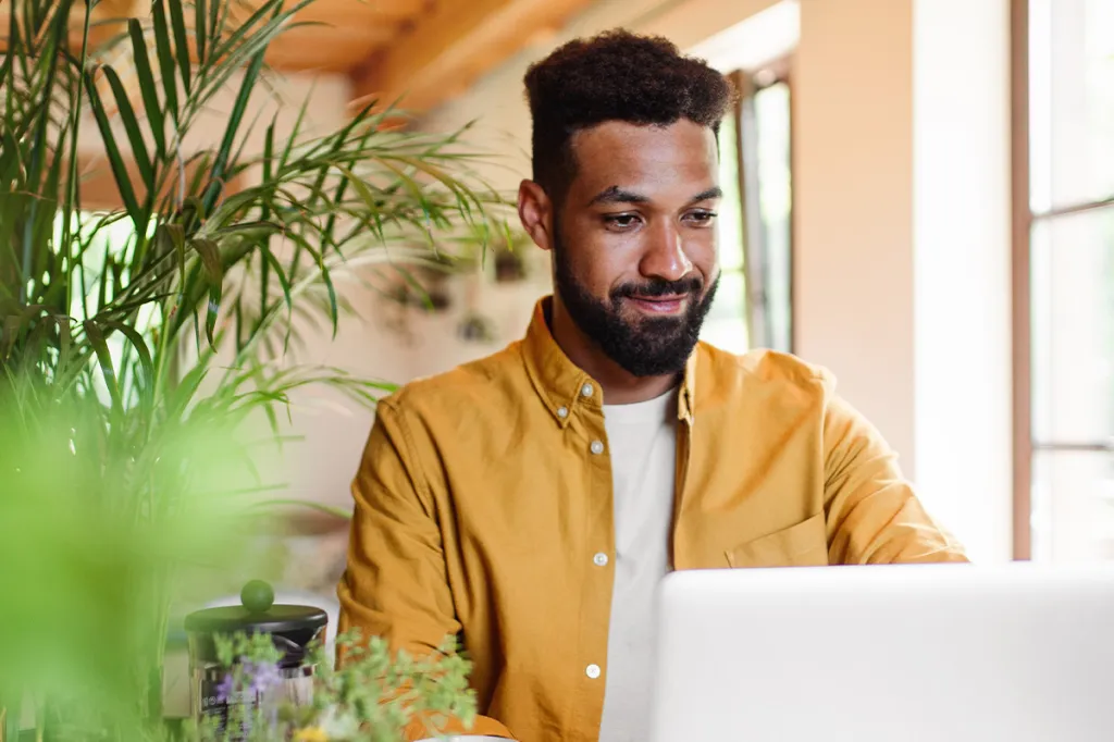 Man reading property management blogs on his laptop
