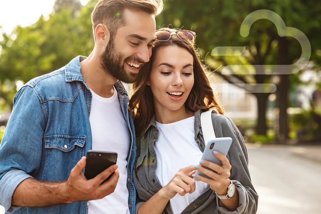 Smiling couple with smartphones