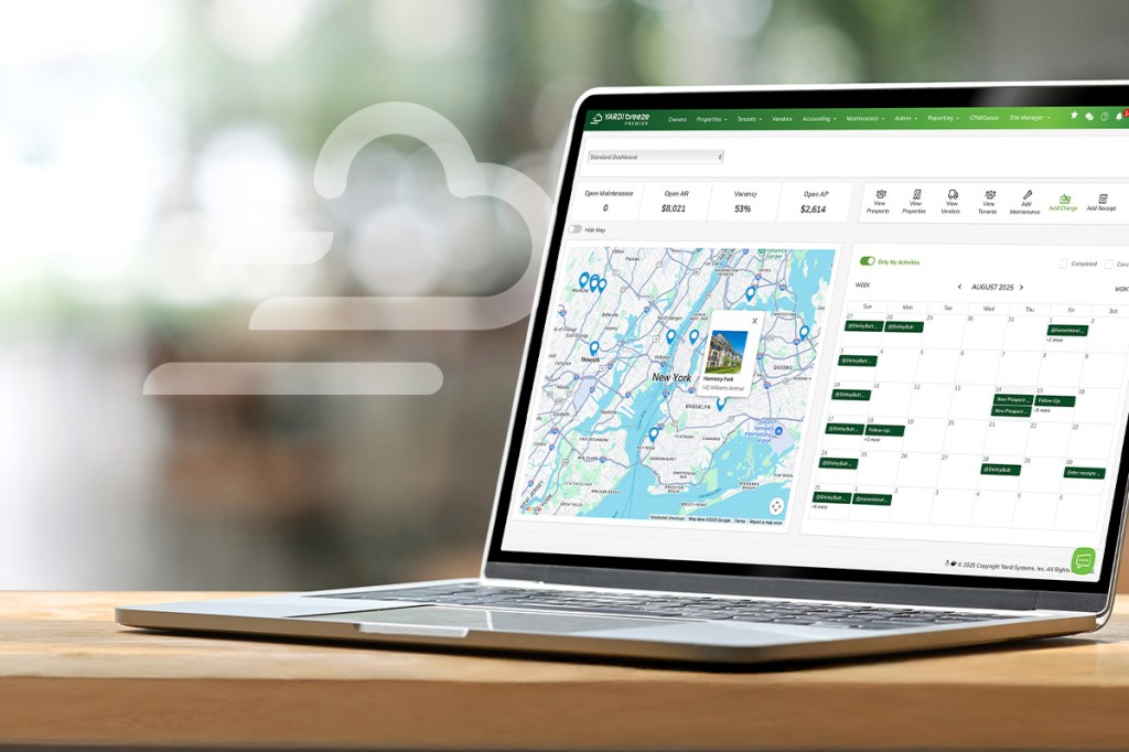 Laptop showing Yardi Breeze property management software dashboard