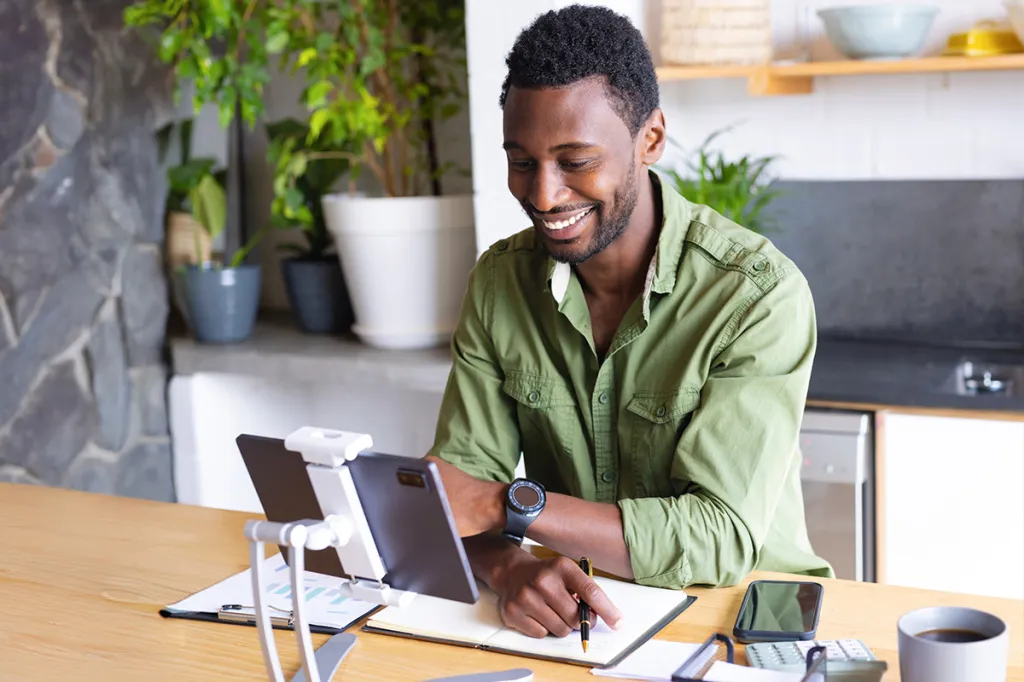 Man working at his desk with a tablet