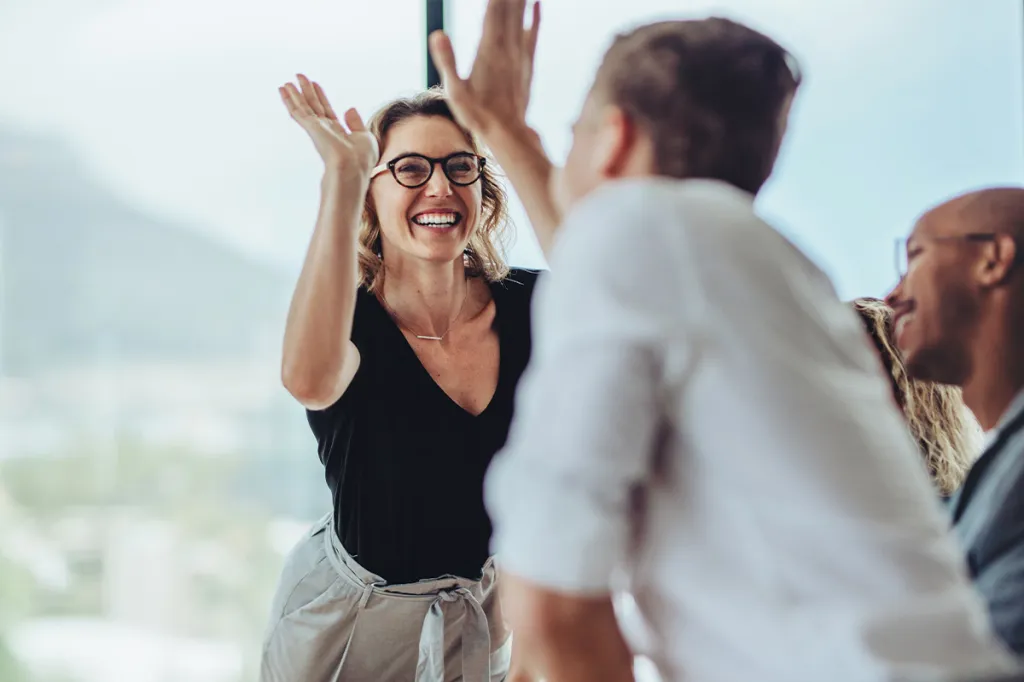 Two professionals giving each other a high five
