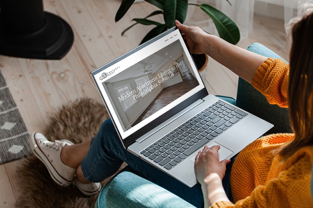 Woman with laptop opento a property management website