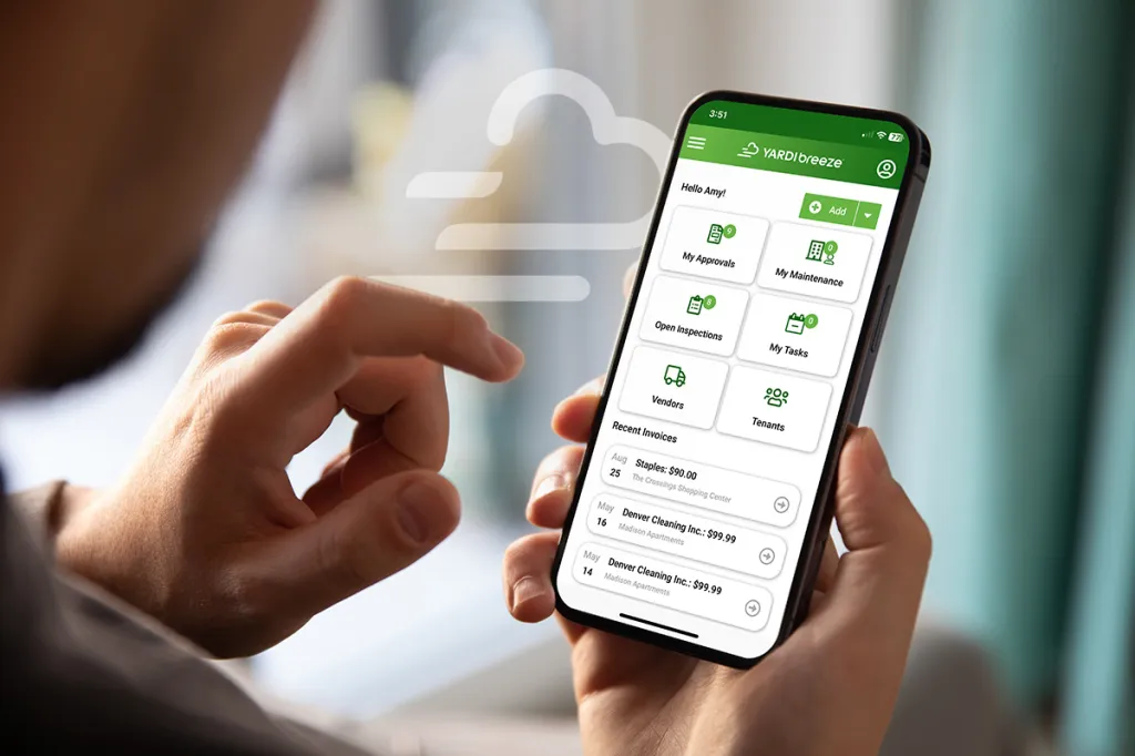 Phone held in hand, displaying Yardi Breeze screen